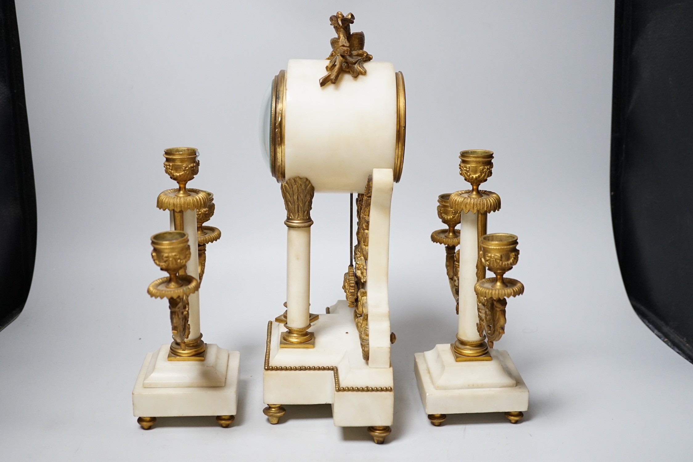 A 19th century alabaster clock garniture, French movement count-wheel striking on a bell, clock 34cm